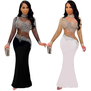 Detailed view of rhinestone embellishments and sheer mesh paneling on fish-tail dresses