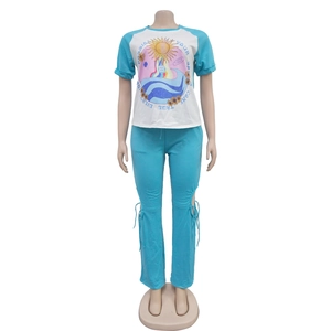 Detail of blue drawstring ruched side on trousers and sun print on white raglan t-shirt