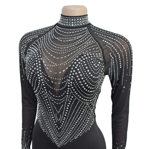Close-up of mesh bodysuit featuring silver rhinestones and geometric sequin patterns