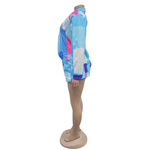 Detail view of women's two-piece suit set featuring blue abstract geometric print pattern