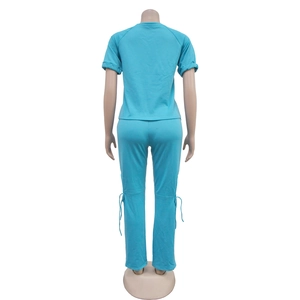 Rear view of light blue two-piece set featuring short sleeves and drawstring side pants