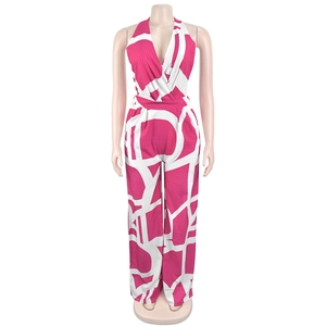 Detailed view of vibrant pink and white geometric print on sleeveless v-neck jumpsuit