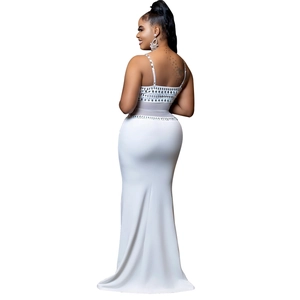 Close-up of white evening dress featuring sheer mesh panels and sparkling rhinestone details