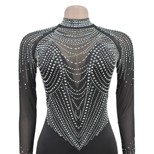 Detail of black mesh dress with intricate silver rhinestone patterns on the neckline