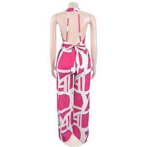 Rear view of pink and white geometric wave print halter neck jumpsuit with backless detail
