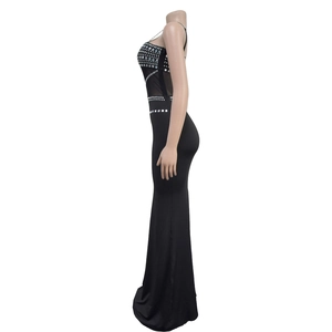 Detail of elegant black mesh mermaid dress featuring intricate rhinestones and sheer panels