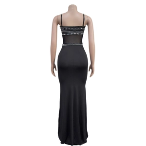 Close-up of sparkling silver rhinestones on the sheer mesh back of a black evening gown