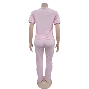 Rear view of pink two-piece tracksuit with short sleeve top and drawstring pants