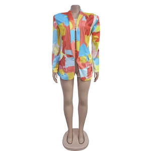 Front detail of long-sleeve blazer featuring abstract colorful graffiti print on white background