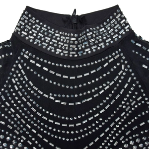 Detail of sheer black mesh dress featuring shimmering silver rhinestones and high neck zip