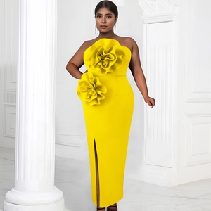 Detail of high-saturation yellow evening dress with 3D floral accents and side slit