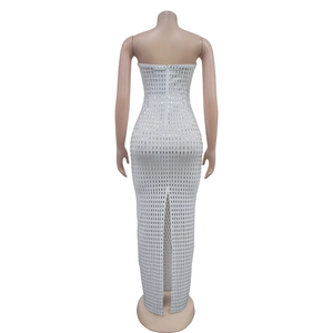 Close-up of the back hidden zipper and slit detail on a white sequin evening dress