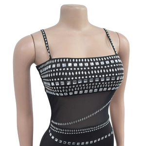 Detail of the sparkling rhinestones and sheer mesh patchwork on the black party dress