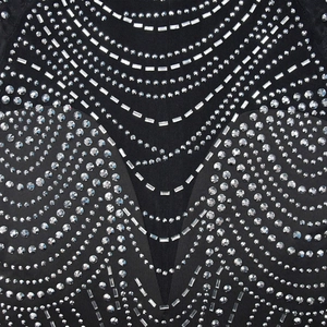 Detail of silver rhinestones and mesh texture on the black evening dress fabric