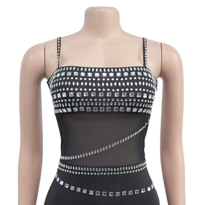 Detail of silver rhinestone geometric patterns on black mesh sleeveless dress