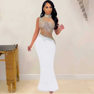 Detailed view of the sparkling rhinestone patterns on white mesh mermaid evening gown