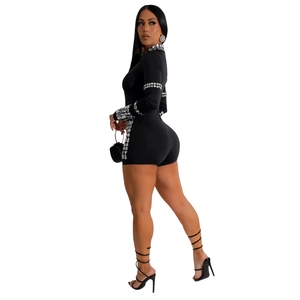 Detail of silver square rhinestones on black long sleeve romper for evening parties