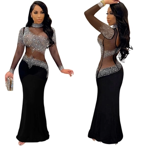 Detail of elegant black fishtail evening dress with silver rhinestones on sheer mesh