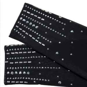 Detail shot of sheer black mesh gloves with glittering crystal rhinestone embellishments