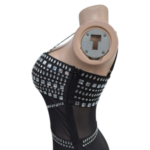 Detail of black rhinestone evening dress featuring sheer mesh panels and hidden side zipper