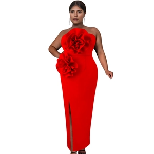 Detail of elegant red strapless dress featuring 3D floral accents and a stylish front slit