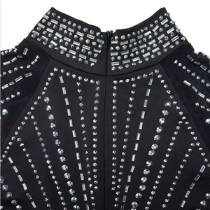Detail of high neck black mesh dress featuring sparkling rhinestones and a back zipper
