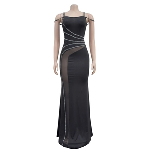 Close-up of black evening gown featuring sheer mesh paneling and silver rhinestone accents