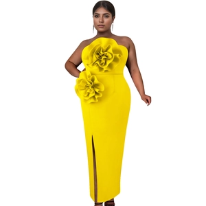 Detail of bright yellow strapless evening dress with 3D floral accents and high side slit