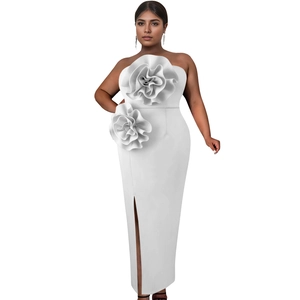 Detail of 3D floral appliqués on a white strapless slim dress with side slit