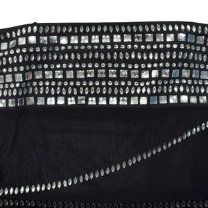Detailed macro view of sparkling rhinestones and crystal patterns on black mesh dress fabric