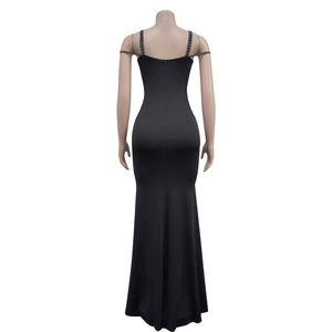 Detail of elegant backless black dress featuring rhinestone-studded shoulder straps