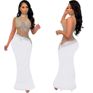 Detail view of sleeveless mesh evening gown with silver rhinestones and white fishtail hem