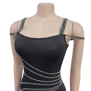 Detailed close-up of silver rhinestones on the neckline of a black mesh dress