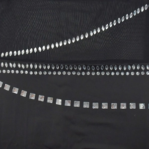 Detail of sheer black mesh fabric with sparkling rhinestones and crystal embellishments