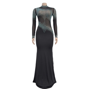 Close-up of sparkling blue rhinestones on black mesh sleeves of the evening dress