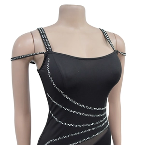 Detail of black rhinestone-embellished bodice with sheer mesh side panels and thin straps