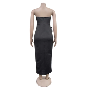 Detail view of back invisible zipper and sleek matte fabric on black strapless dress