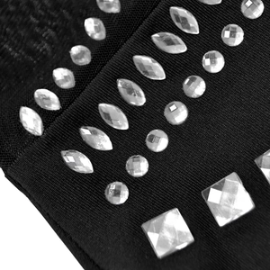 Close-up of sparkling rhinestones and delicate mesh fabric on a black elegant dress
