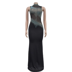 Detail of black evening dress featuring sheer mesh panels and blue rhinestone patterns