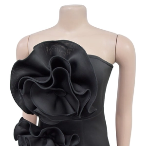 Detail of elegant black strapless dress featuring a large 3D mesh rose on the chest