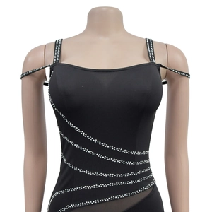 Close-up of black bodycon dress featuring mesh panels and silver rhinestone stripes