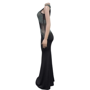 Close-up of black bodycon dress featuring rhinestone mesh and halter neckline detail