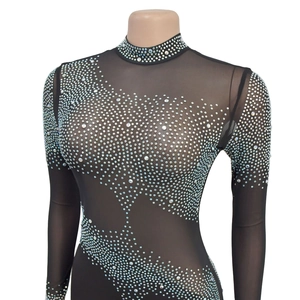 Detailed view of colorful rhinestones on black mesh fabric for a long-sleeved dress