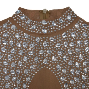 Detail of sheer brown mesh neckline with intricate rhinestone patterns and hidden back zipper
