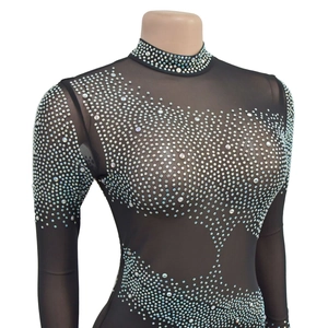 Detail of black mesh bodysuit featuring shimmering silver rhinestones in wave patterns