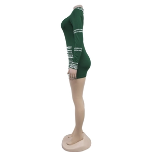 Detailed view of silver rhinestones on the cuff and side of dark green mini dress