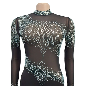 Detailed view of black mesh top with intricate white rhinestone geometric patterns