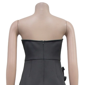 Close-up of black strapless dress featuring back invisible zipper and side ruffle detail