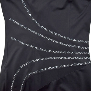Detail of black rhinestone patterns on mesh fabric of the elegant women's dress