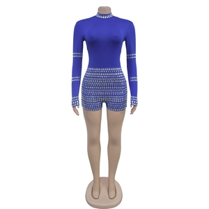 Detailed view of royal blue sequin bodysuit with silver rhinestones on collar and cuffs